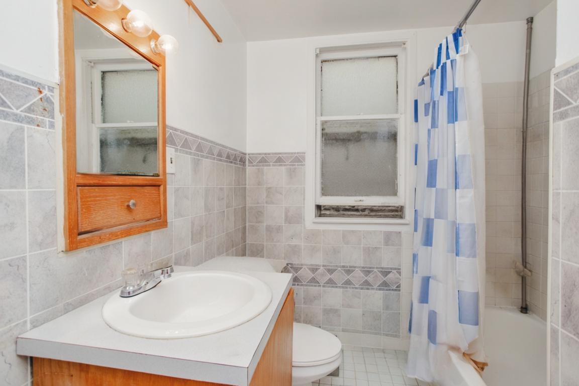 2453 North Tripp Avenue Chicago, IL 60639 - Photo 9 of 17 a bathroom with a sink toilet and shower