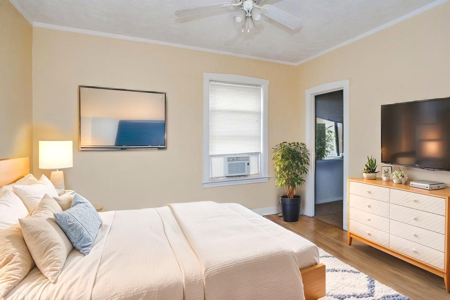 2453 North Tripp Avenue Chicago, IL 60639 - Photo 10 of 17 a bedroom with a bed and a flat screen tv