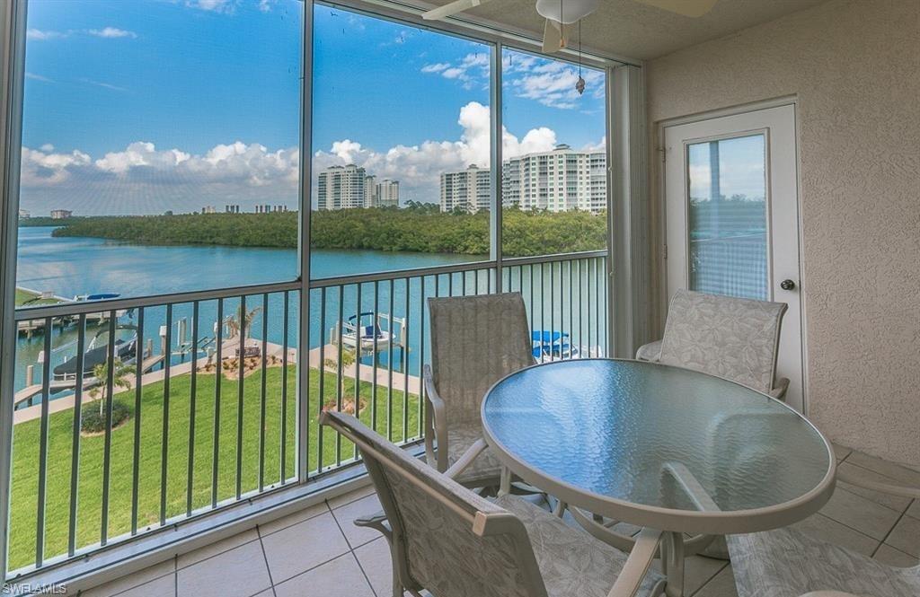a view of a balcony with lake view and a floor to ceiling window