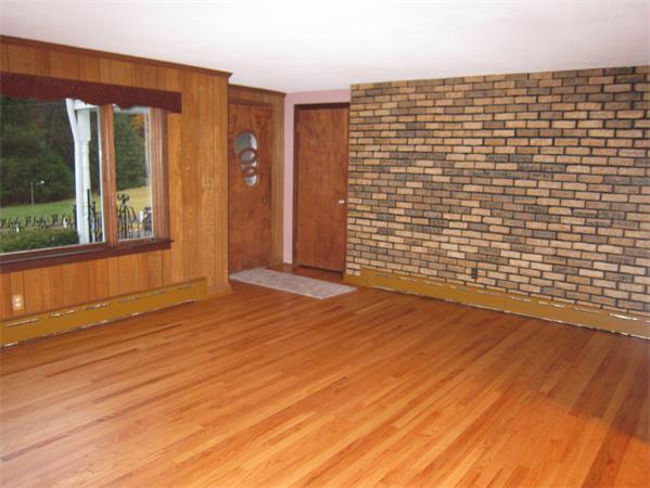 76 Ridgewood Drive Russell, MA 01071 - Photo 4 of 30 an empty room with wooden floor and windows