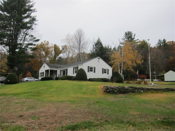 76 Ridgewood Drive Russell, MA 01071 - Photo 6 of 30 a house that is sitting in the grass with large trees and plants