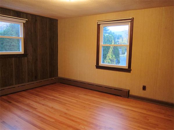 76 Ridgewood Drive Russell, MA 01071 - Photo 7 of 30 a view of an empty room with wooden floor and a window