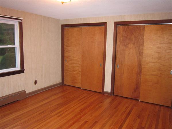 76 Ridgewood Drive Russell, MA 01071 - Photo 8 of 30 an empty room with wooden floor and windows