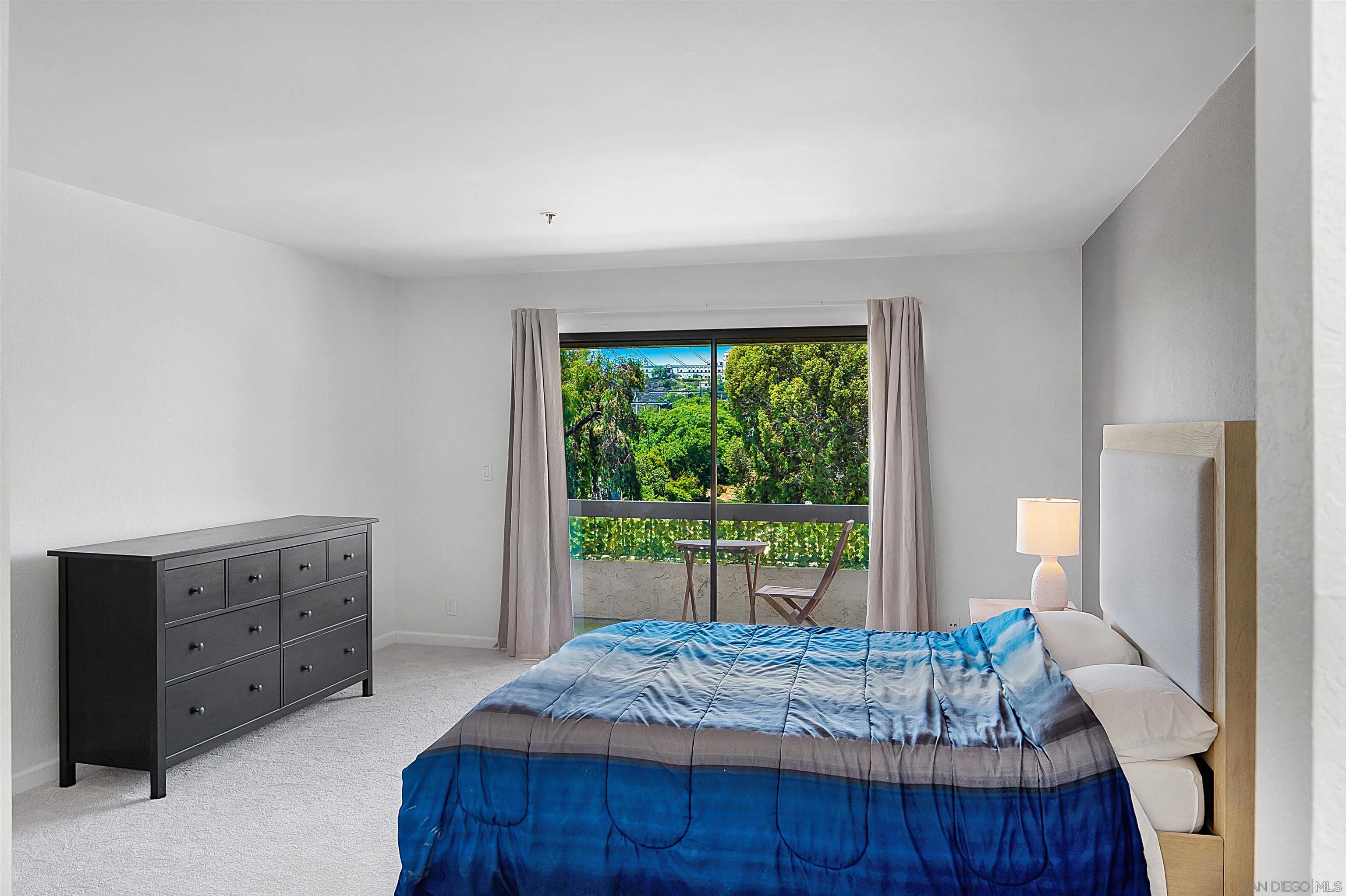 5605 Friars Road, Unit 304 San Diego, CA 92110 - Photo 11 of 37 a bed sitting in a bedroom next to a window