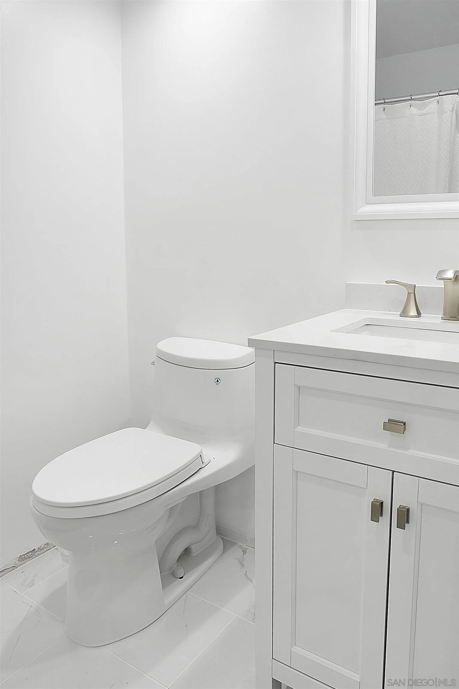 5605 Friars Road, Unit 304 San Diego, CA 92110 - Photo 15 of 37 a white toilet sitting next to a bathroom sink