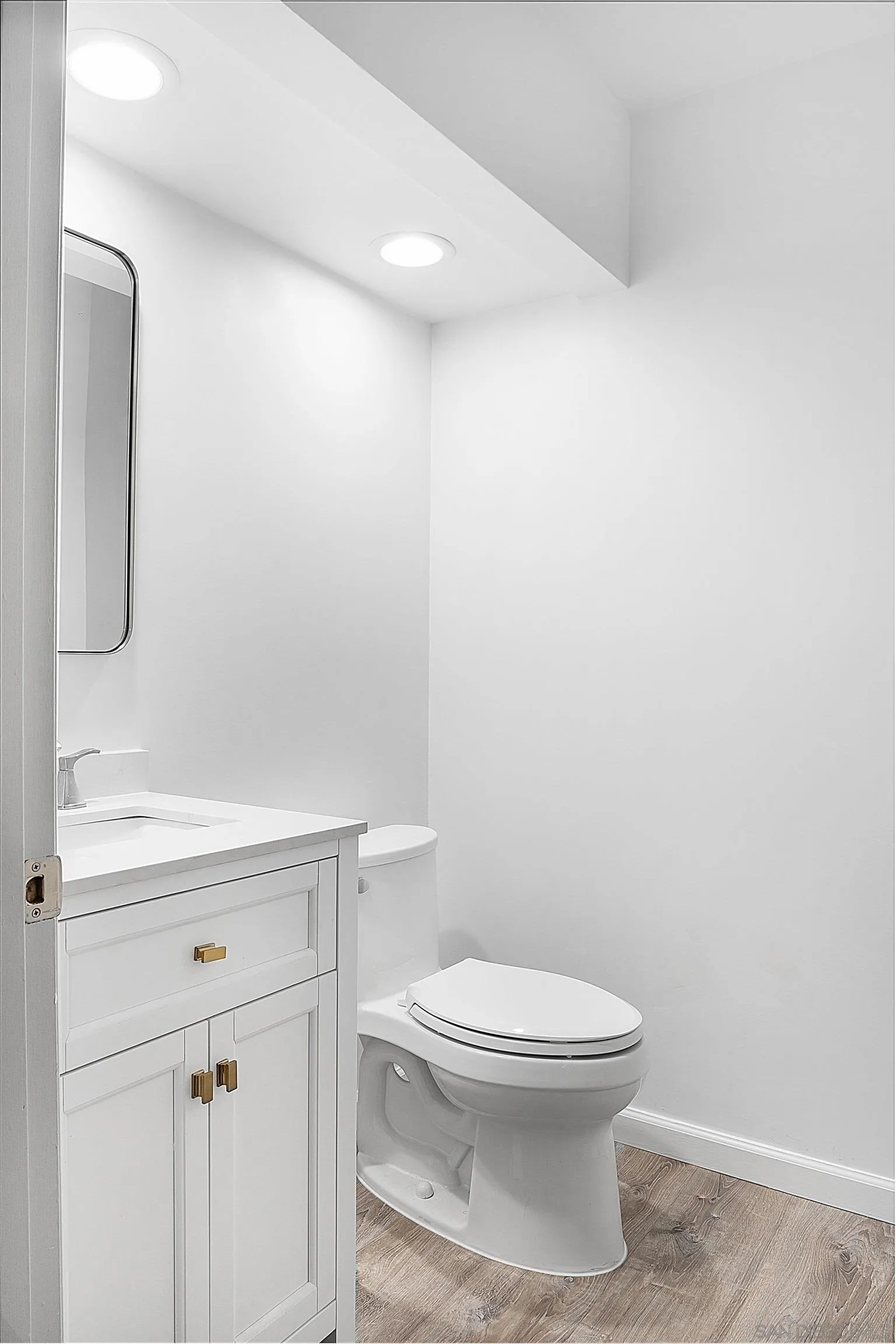 5605 Friars Road, Unit 304 San Diego, CA 92110 - Photo 18 of 37 a bathroom with a toilet a sink and mirror