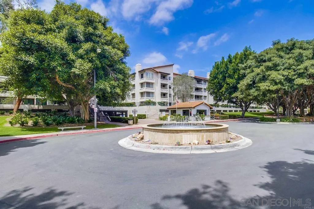 5605 Friars Road, Unit 304 San Diego, CA 92110 - Photo 3 of 37 a view of a house with a fountain and a tree