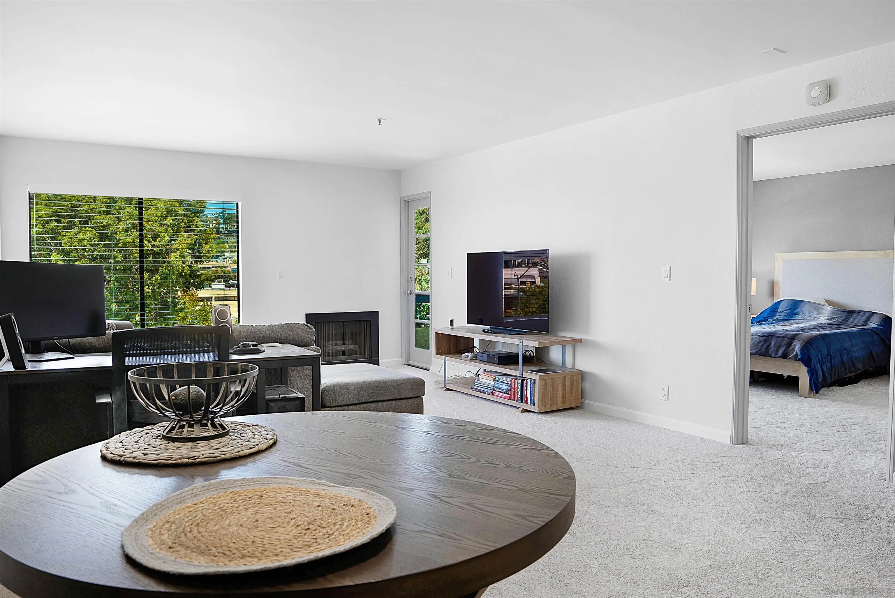 5605 Friars Road, Unit 304 San Diego, CA 92110 - Photo 4 of 37 a living room with furniture and a flat screen tv