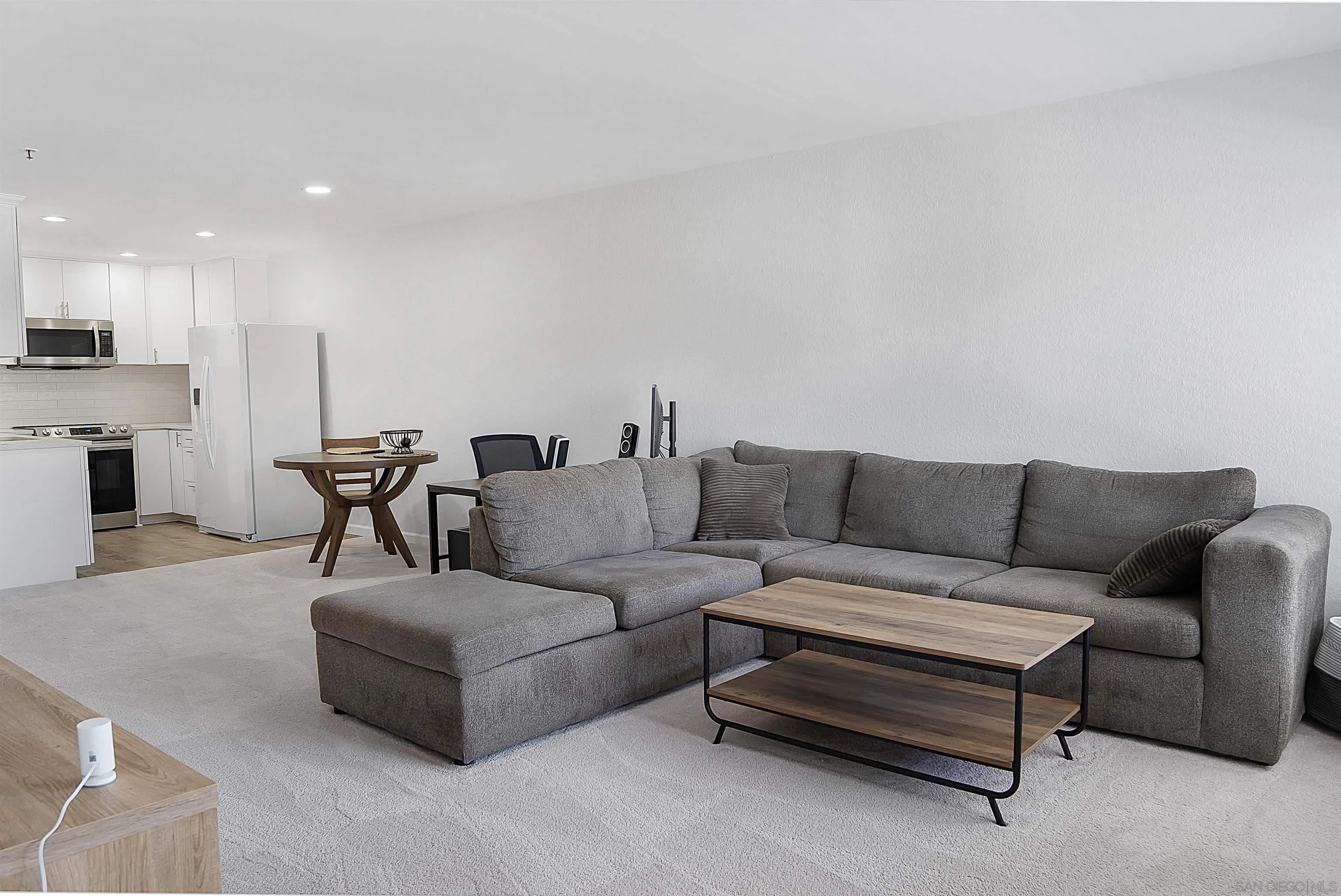 5605 Friars Road, Unit 304 San Diego, CA 92110 - Photo 7 of 37 a living room with furniture and kitchen view
