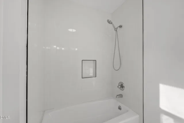 a bathroom with a bath tub and shower