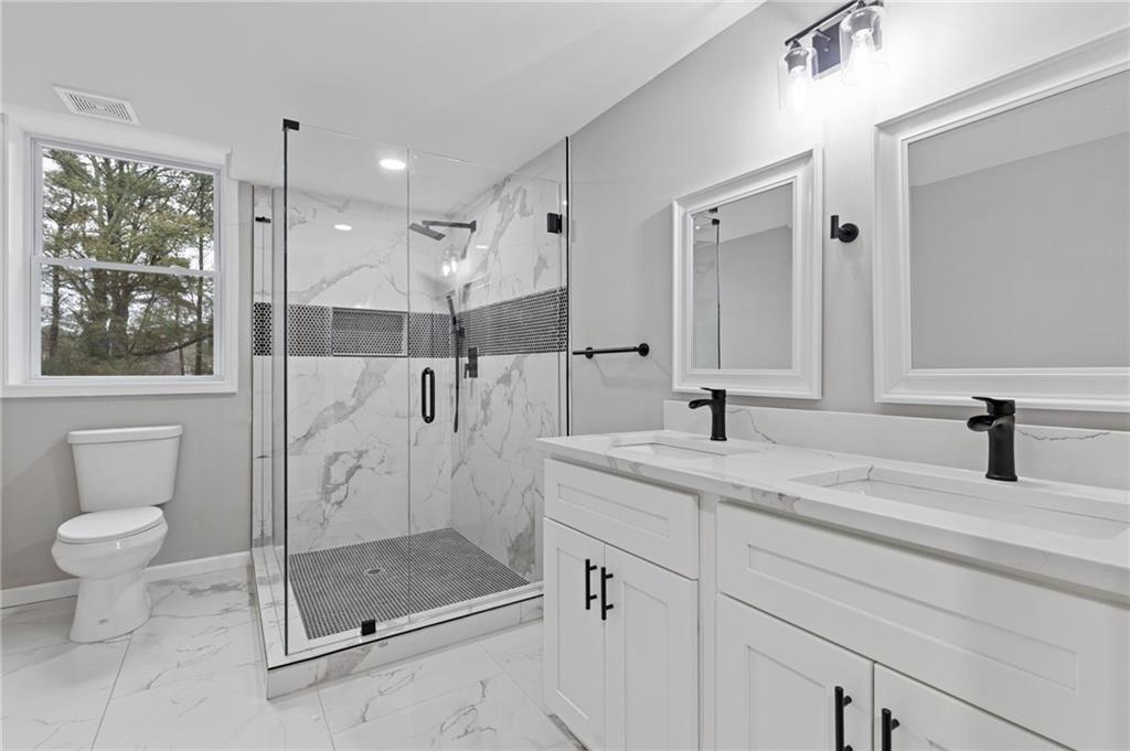 2224 Hudson Drive Southwest Lilburn, GA 30047 - Photo 22 of 30 a bathroom with a granite countertop sink mirror and toilet
