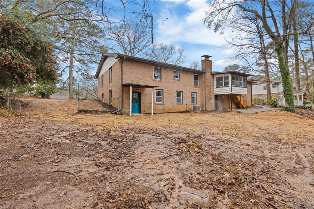 2224 Hudson Drive Southwest Lilburn, GA 30047 - Photo 28 of 30 a front view of a building with large trees