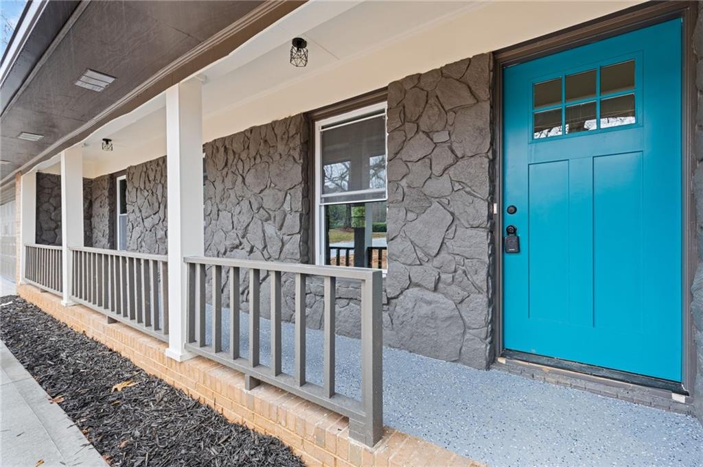 2224 Hudson Drive Southwest Lilburn, GA 30047 - Photo 4 of 30 a view of a brick house with a small yard