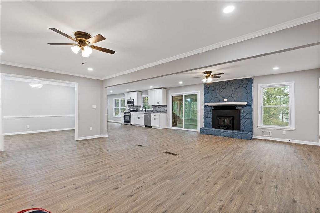 2224 Hudson Drive Southwest Lilburn, GA 30047 - Photo 5 of 30 a view of an empty room with a fireplace and a window