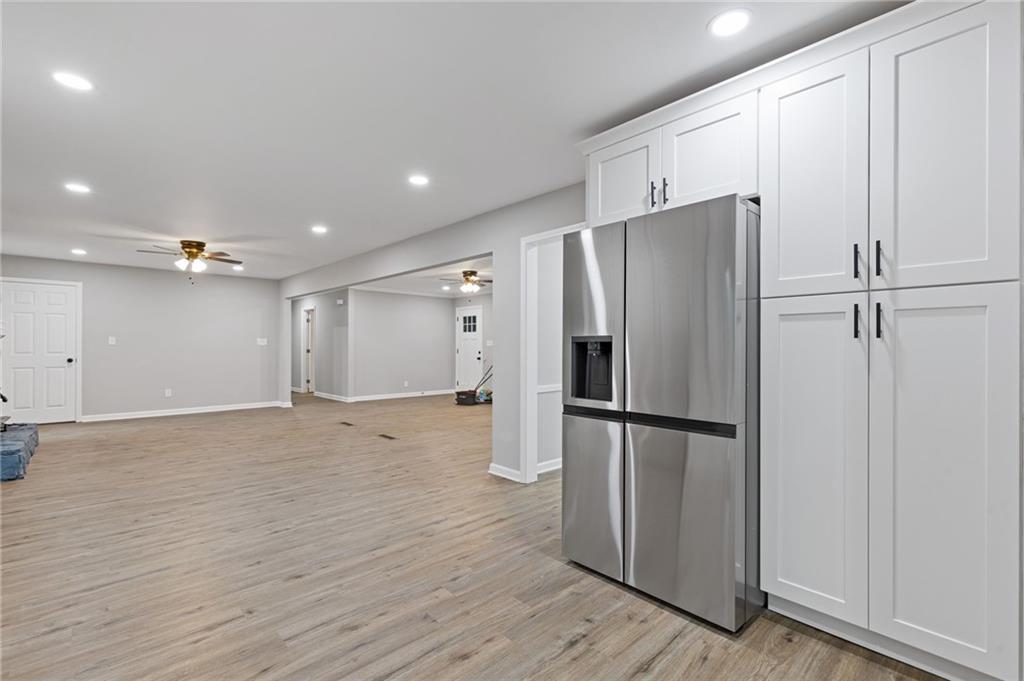 2224 Hudson Drive Southwest Lilburn, GA 30047 - Photo 9 of 30 a view of a kitchen with a refrigerator and wooden floor