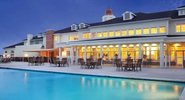 a view of a swimming pool with outdoor seating