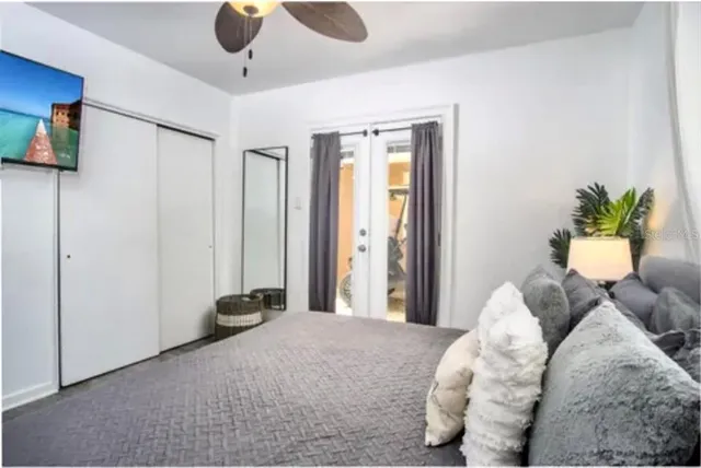 a bedroom with bed and a chandelier