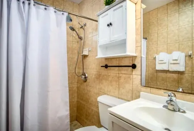 a bathroom with a sink a mirror and a shower