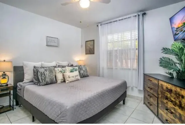 a bedroom with a bed and a window