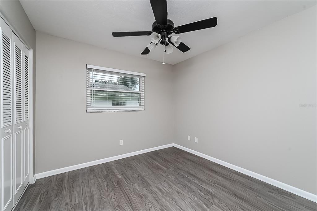 6416 Chippendale Road Lakeland, FL 33809 - Photo 13 of 16 wooden floor in an empty room with a window