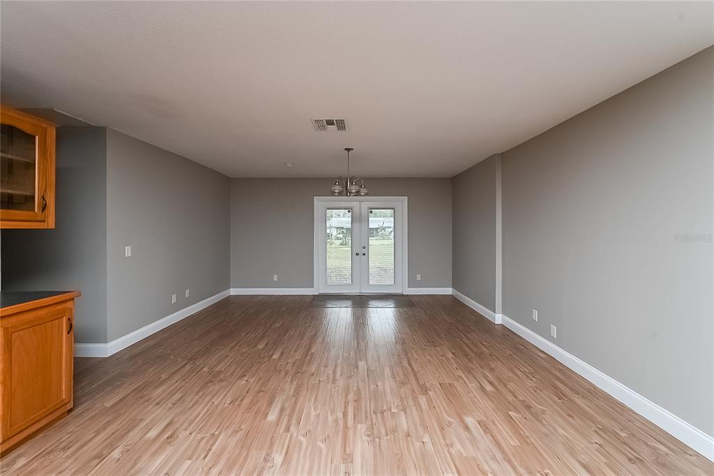 6416 Chippendale Road Lakeland, FL 33809 - Photo 2 of 16 wooden floor in an empty room with a window