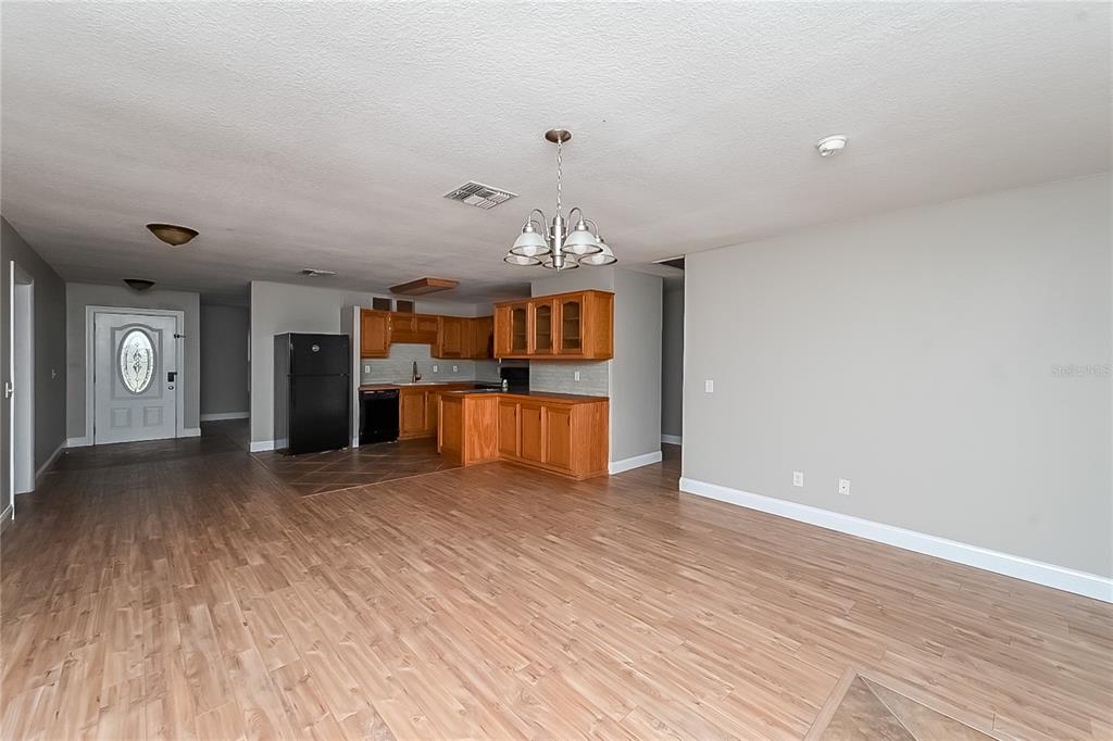 6416 Chippendale Road Lakeland, FL 33809 - Photo 3 of 16 a view of a big room with wooden floor and staircase