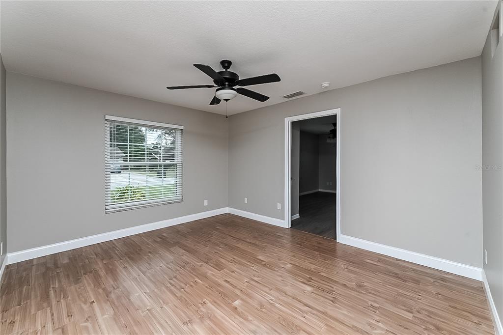 6416 Chippendale Road Lakeland, FL 33809 - Photo 4 of 16 a view of an empty room with wooden floor and a window