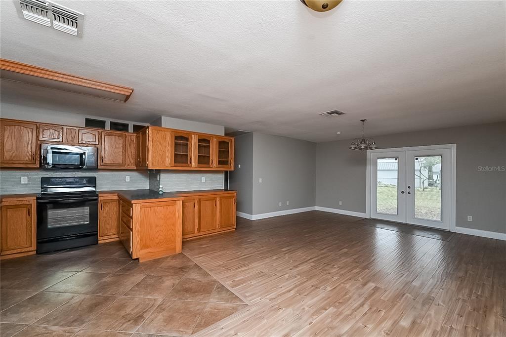 6416 Chippendale Road Lakeland, FL 33809 - Photo 5 of 16 an empty room with wooden floor and windows
