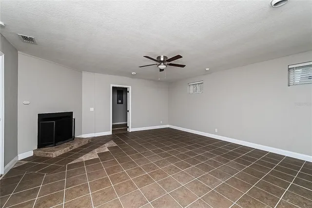 a view of an empty room with a ceiling fan