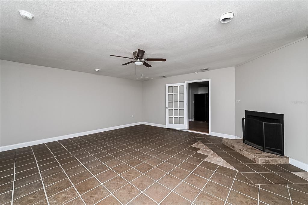 6416 Chippendale Road Lakeland, FL 33809 - Photo 9 of 16 a view of an empty room with a fireplace