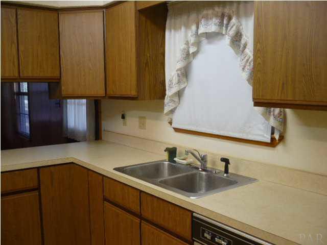 THE KITCHEN HAS PLENTY OF CABINET, COUNTERTOP SPACE AND PANTRY