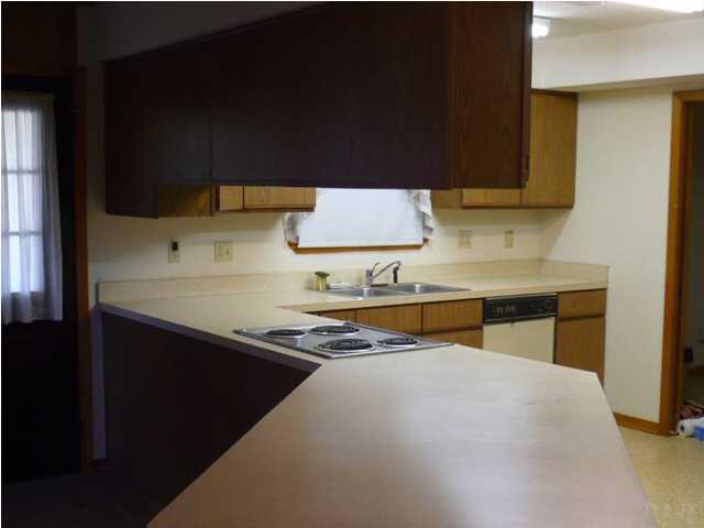 EXTENDED BAR AREA OF KITCHEN. THE FAMILY ROOM IS TO THE LEFT OF KITCHEN BAR AREA