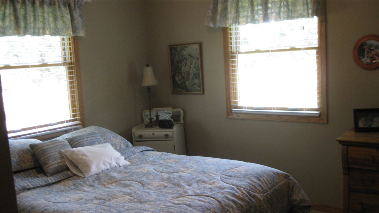 5549 North Stillman Road Stillman Valley, IL 61084 - Photo 14 of 22 a bedroom with a bed and a window