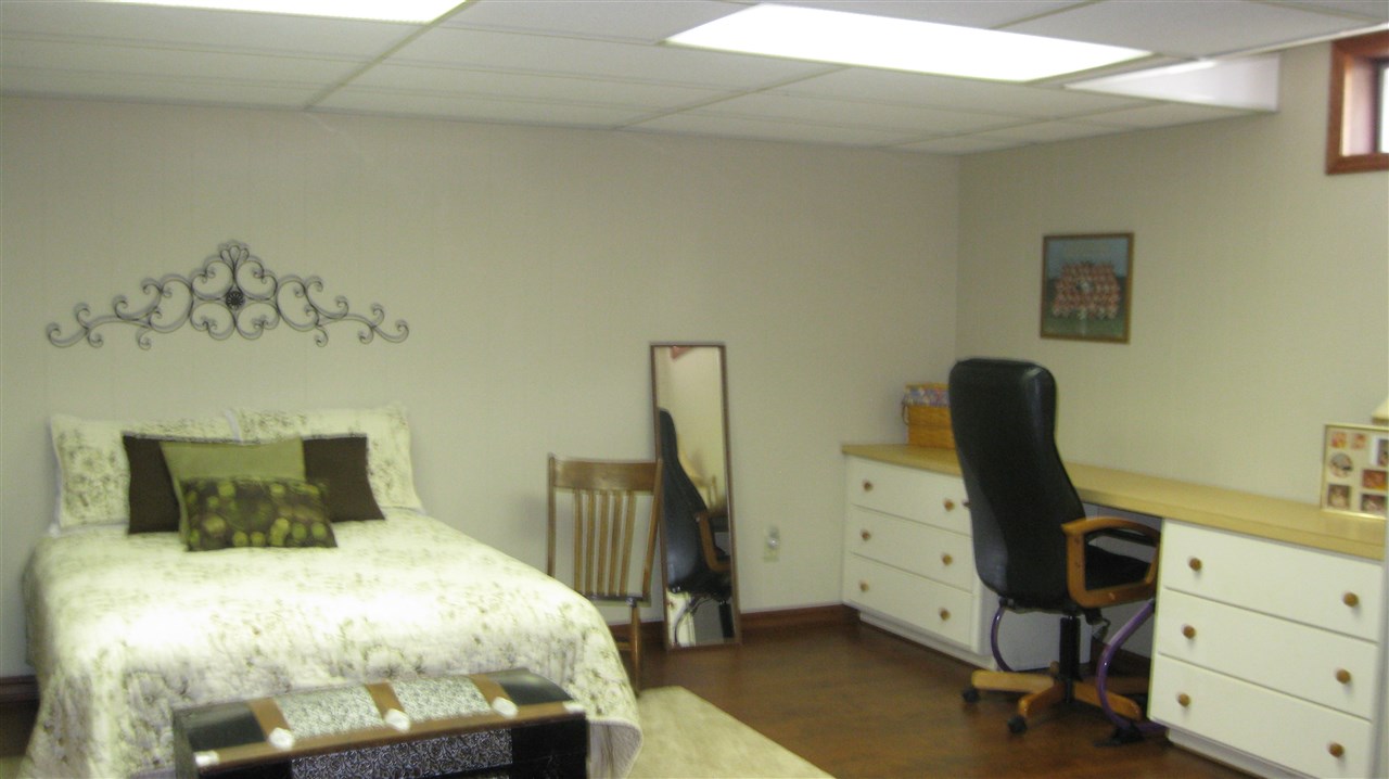 5549 North Stillman Road Stillman Valley, IL 61084 - Photo 20 of 22 a bedroom with a bed and a desk