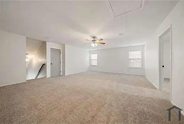 a view of an empty room with a window