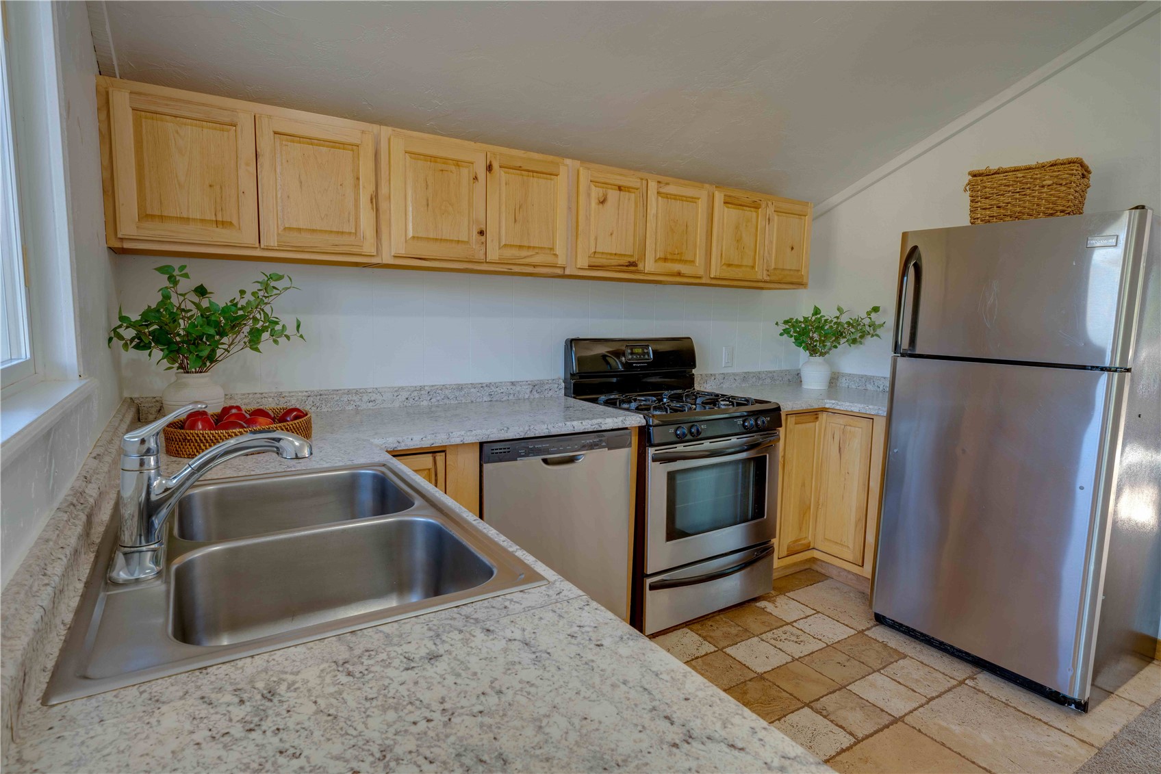 746 Edgewood Road Alma, CO 80420 - Photo 12 of 32 Kitchen featuring stainless steel appliances, sink, vaulted ceiling, and light brown cabinetry