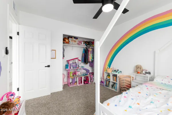 a bedroom with furniture and a wooden floor