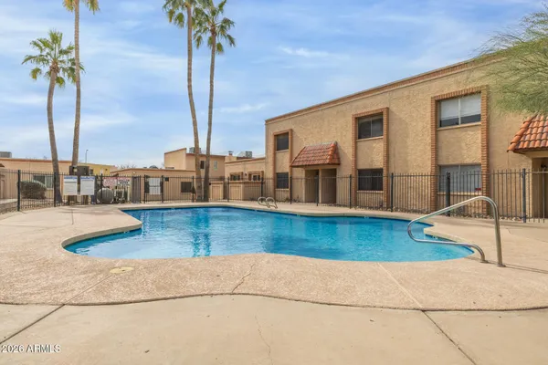 a swimming pool with outdoor seating and yard
