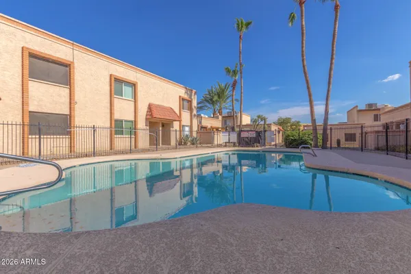 a swimming pool with outdoor seating and yard