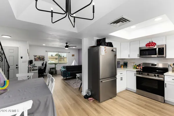a kitchen with stainless steel appliances granite countertop a refrigerator stove and sink