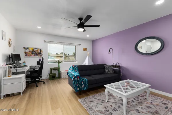 a living room with furniture and a wooden floor
