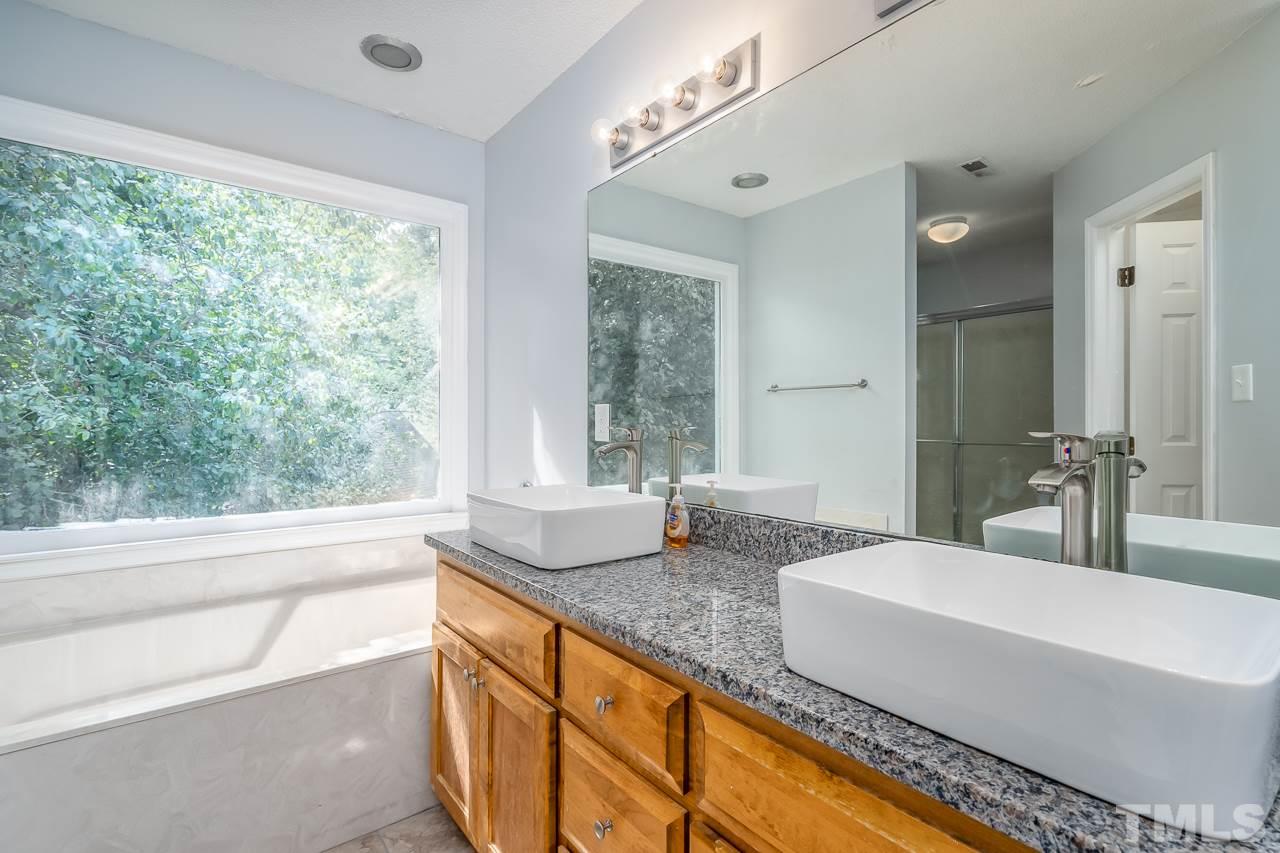 4500 Knightsbridge Way Raleigh, NC 27604 - Photo 12 of 24 a bathroom with a granite countertop sink and a large mirror