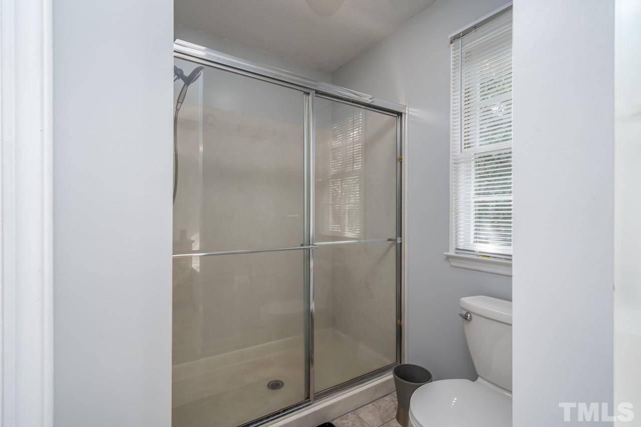 4500 Knightsbridge Way Raleigh, NC 27604 - Photo 13 of 24 a bathroom with a shower and toilet