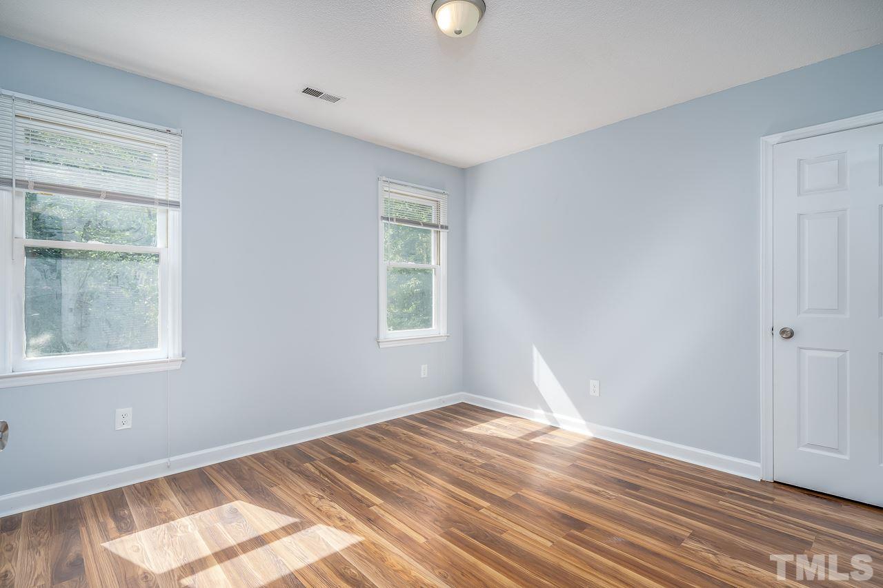 4500 Knightsbridge Way Raleigh, NC 27604 - Photo 16 of 24 an empty room with wooden floor and windows