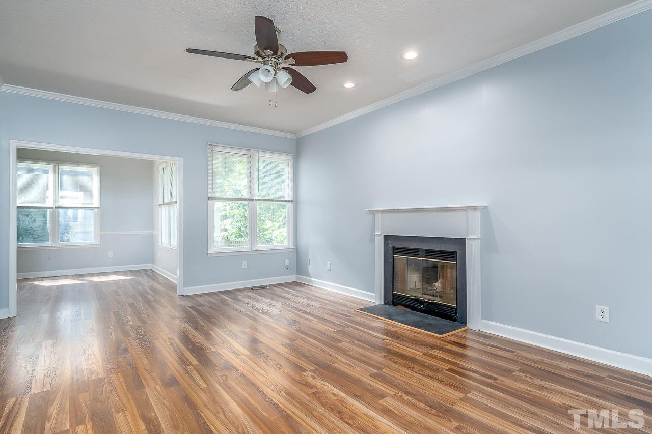 4500 Knightsbridge Way Raleigh, NC 27604 - Photo 3 of 24 an empty room with windows fireplace and wooden floor
