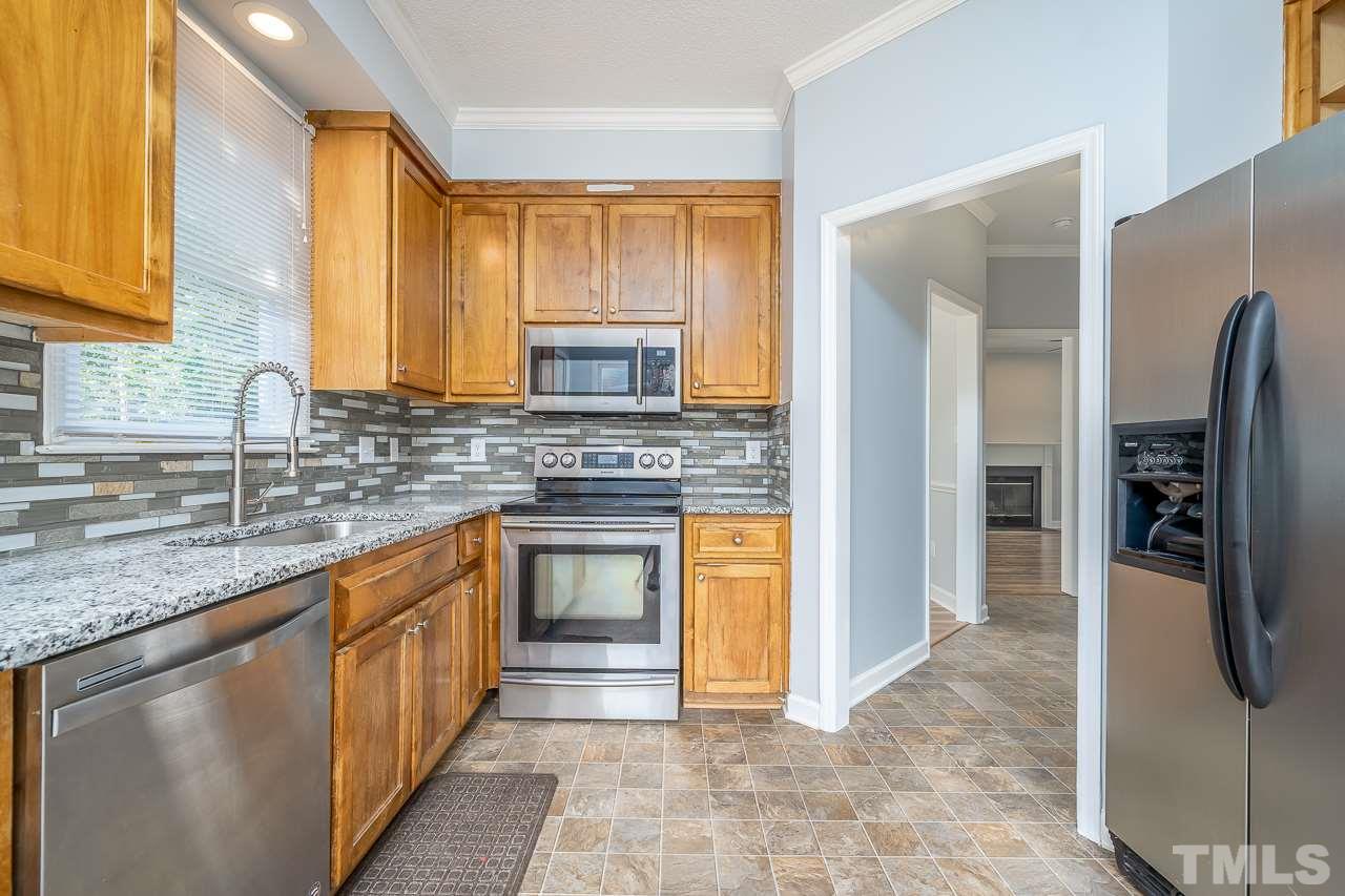 4500 Knightsbridge Way Raleigh, NC 27604 - Photo 4 of 24 a kitchen with stainless steel appliances granite countertop a refrigerator and a sink