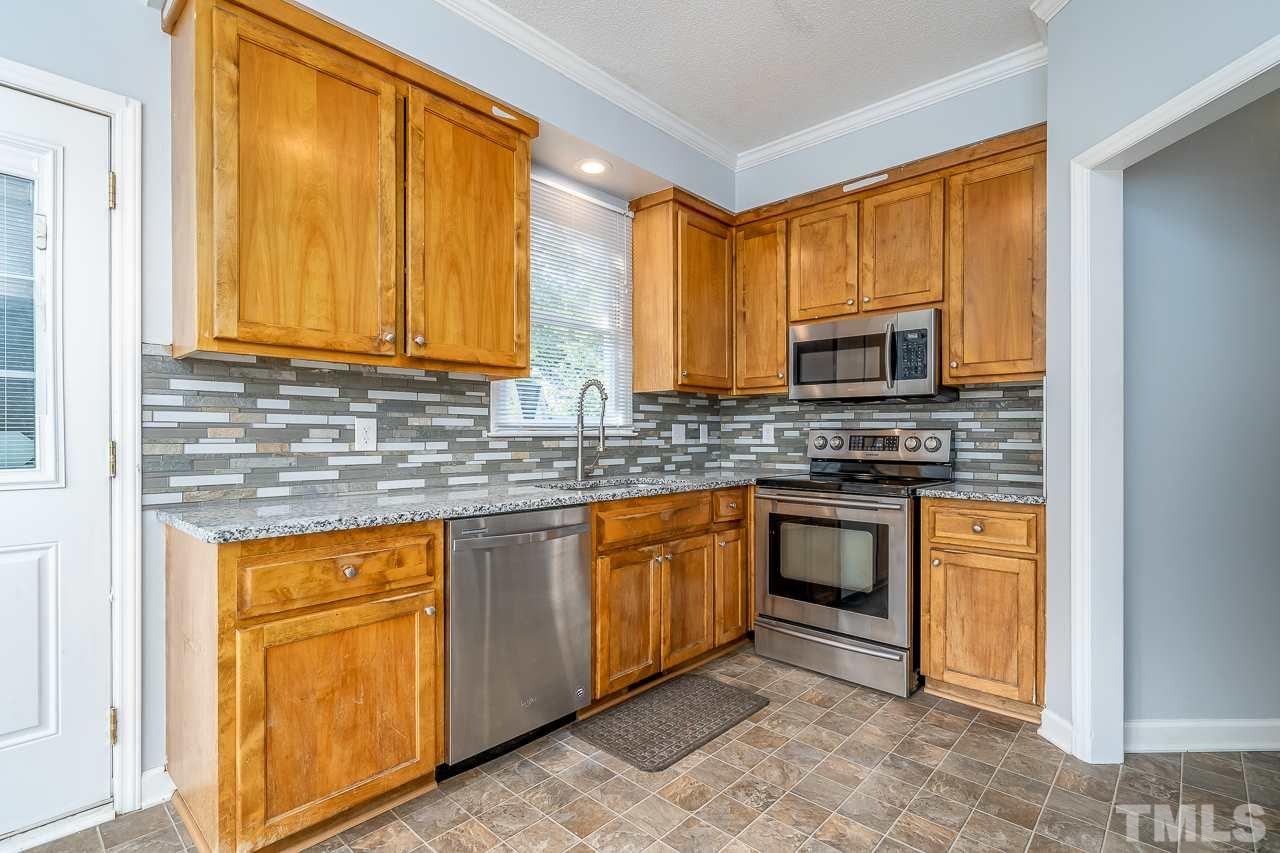 4500 Knightsbridge Way Raleigh, NC 27604 - Photo 5 of 24 a kitchen with stainless steel appliances granite countertop wooden cabinets a sink and a granite counter tops