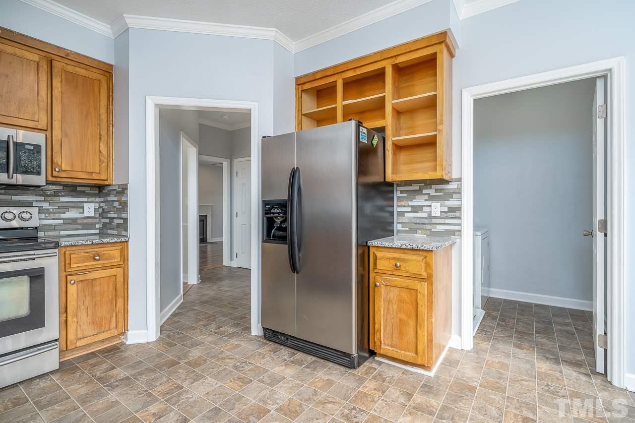 4500 Knightsbridge Way Raleigh, NC 27604 - Photo 6 of 24 a view of a kitchen with a refrigerator and a stove top oven