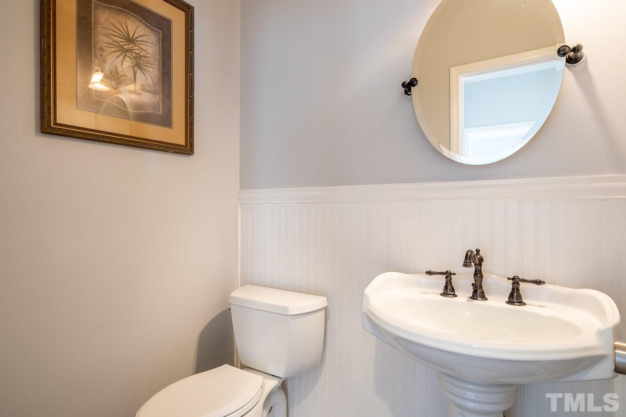 4500 Knightsbridge Way Raleigh, NC 27604 - Photo 9 of 24 a white toilet sitting next to a bathroom sink