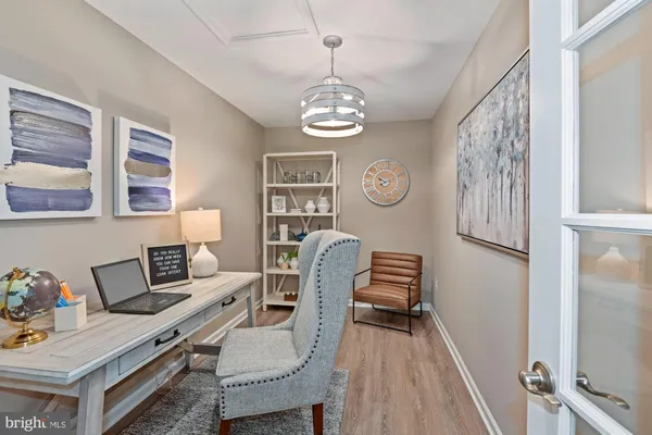 a view of a hallway with workspace and dining area